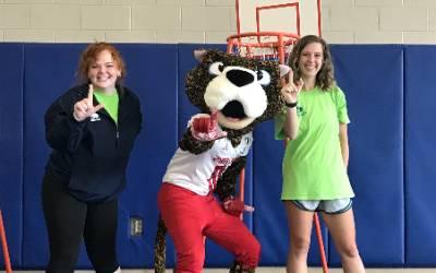 Summer Camp counselors with Southpaw in gym.